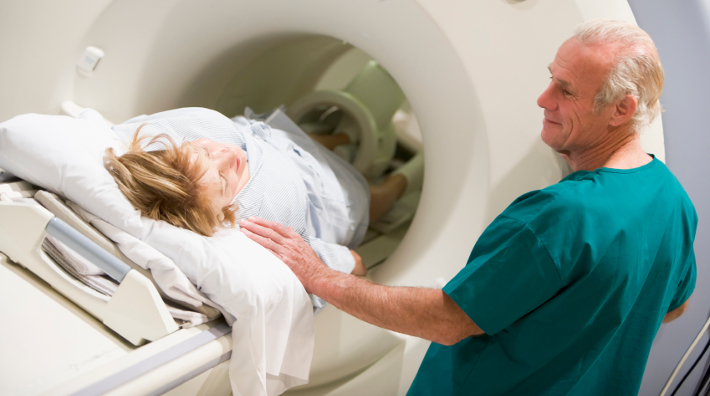 Doctor with Patient During CT Scan